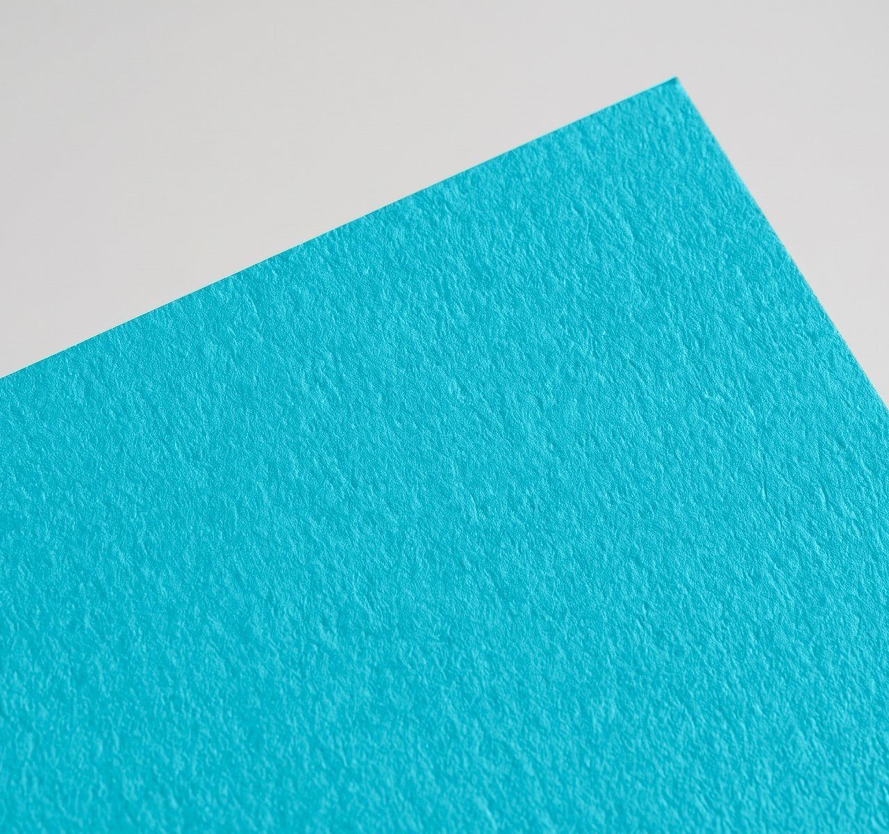 Sirio Color Rough Teal, Teal, rough, high-bulk uncoated, pulp-dyed paper swatch