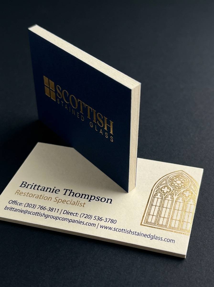 Concept 3: The Wildcard concept: 32pt duplex cardstock (navy/cream with cream core reveal) · Flat metallic gold foil · Offset 2-colour print